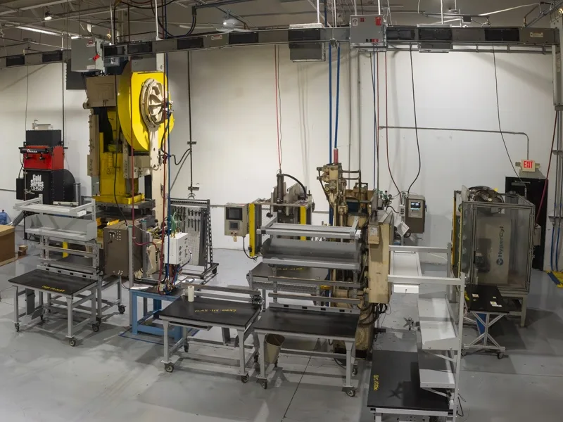 A high-angle view of a bay on a manufacturing floor with various pieces of equipment for specialized custom tooling A high-angle view of a bay on a manufacturing floor with various pieces of equipment for specialized custom tooling