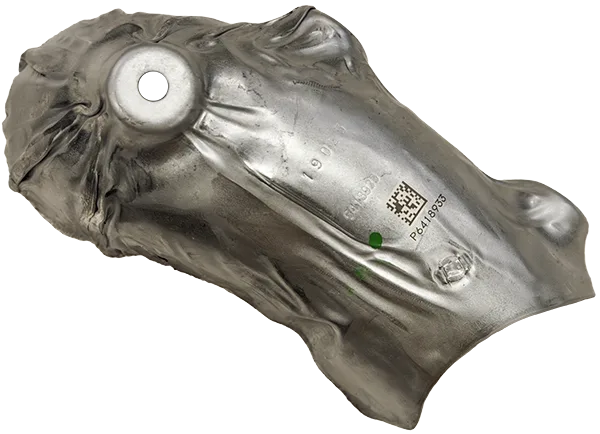 A heat shielf stamped with part numbers and a QR code A heat shielf stamped with part numbers and a QR code