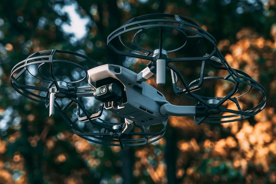 A commercial drone with camera in flight A commercial drone with camera in flight