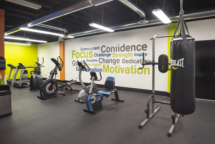 Soundwich employee fitness center Interior of Soundwich's well-lit fitness area including punching bag, dip rack, recumbent bike, ellipticals, and treadmills. Our support of employees' well-being makes working at Soundwich way more than a job.