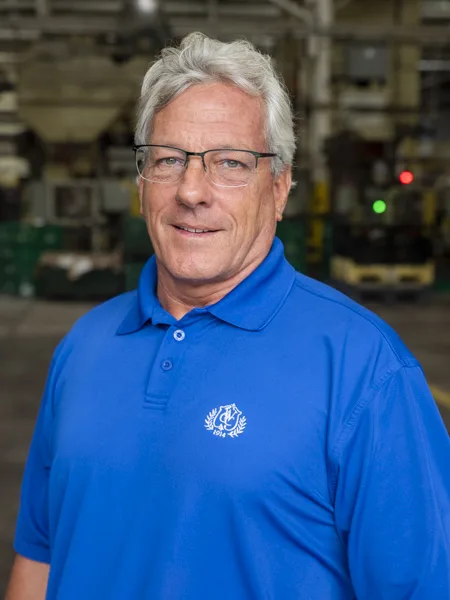 Rick Renton, Soundwich's Director of Materials. Rick Renton, Soundwich's Director of Materials. He has silver hair and is wearing a blue polo shirt and glasses.