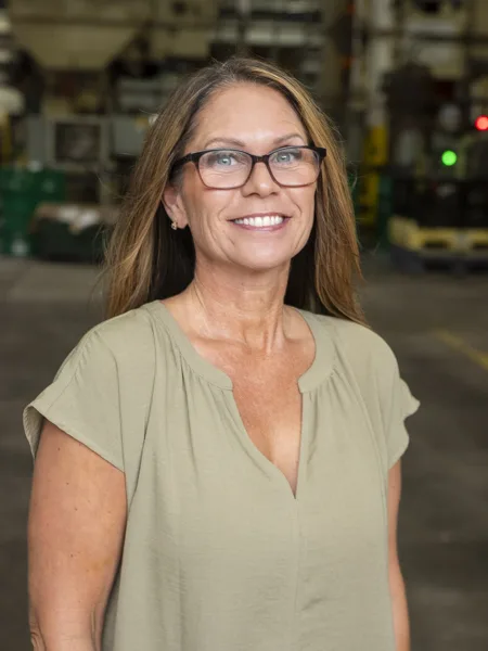 Tami Hollis, Soundwich's Human Resources Manager Tami Hollis is Soundwich's Human Resources Manager. She has long medium-brown hair and is wearing a short-sleeved pale green shirt and glasses.